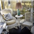 F26. White wicker rockers and white painted side table. 